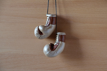 Old boxing gloves, leather boxing gloves, hanging on wooden wall