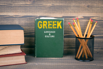 Greek language and culture concept. Book on a wooden background