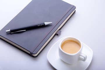 office table with notebook, computer keyboard,, cup of coffee, tablet pc. copy space.