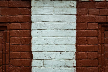 Texture of an old red brick wall background with a strip of white paint