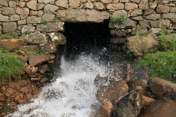 Water jet pouring out of a water mill located in Khizana, a beautiful natural environment close to...