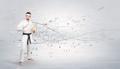 Young karate trainer doing karate tricks with chaotic concept
