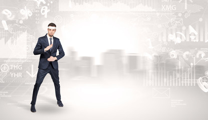 Young suited karate trainer doing karate tricks on the top of a metropolitan city