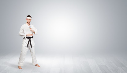 Young kung-fu trainer fighting in an empty space
