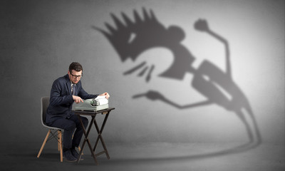 Man working hard and he is afraid of a yelling shadow
