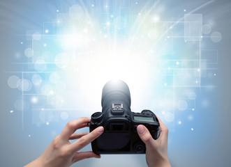 Naked hand taking picture with digital camera and glowing flash concept
