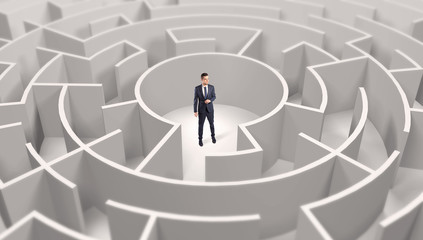 Young businessman standing in a middle of a 3d round maze
