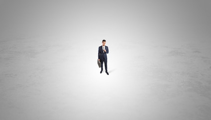 Young businessman standing alone in the middle of an empty space
