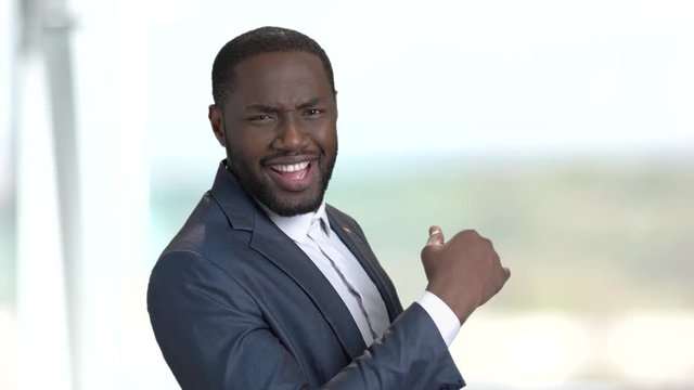Surprised macho-man on blurred background. Portrait of sexy amazed afro-american businessman. Human facial expressions and body language. Hot macho-man.