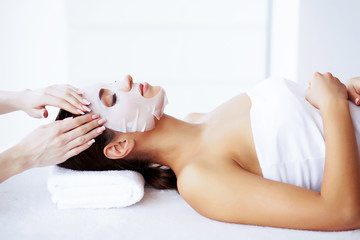 Obraz na płótnie Canvas Beauty and Care. Beautiful Young Girl in Spa Salon. Facial Procedures. Face Mask. Girl with Pure and Beautiful Skin. High Resolution