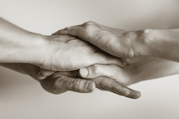 Two people's hands united. People working together, teamwork concept. 