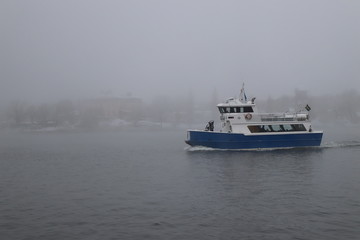 Fototapeta na wymiar Ferry in winter mist