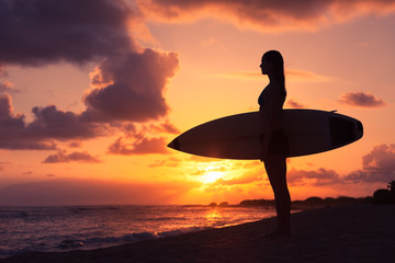 Fototapeta na wymiar Surfer girl standing on the beach. Beach life concept. 