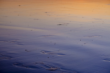 Footprints on the beach at dusk