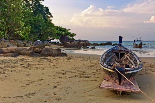 Boat on the beach at sunset