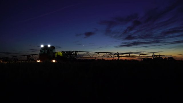 Machine for spraying pesticides and herbicides in the field at night work. 4K video