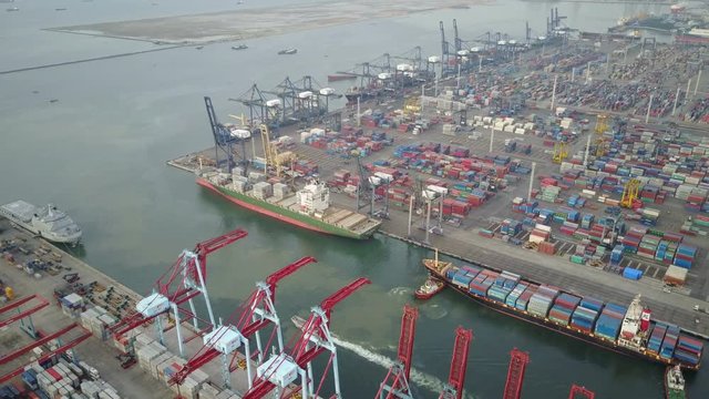 Aerial view of cranes and cargo vessels in container terminal port in Jakarta, industrial Indonesia