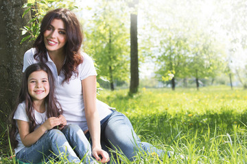 Young mother and daughter in park