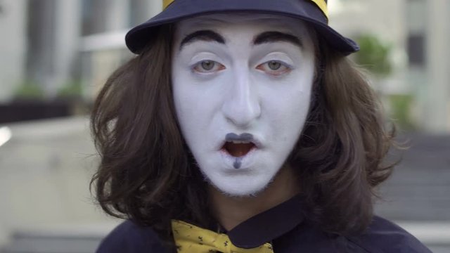 Mime in hat flirting with camera