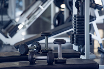Fototapeta na wymiar Close up of modern dumbbells equipment in the sport gym , gym equipment concept.