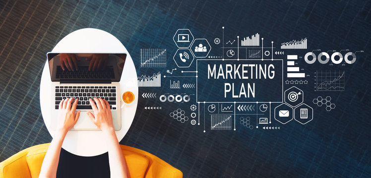 Marketing Plan with person using a laptop on a white table