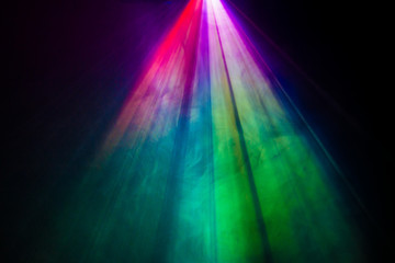 beautiful rainbow color wide lens projector with light beam for movie and cinema at night . smoke texture spotlight . screening for multimedia . black background . - obrazy, fototapety, plakaty