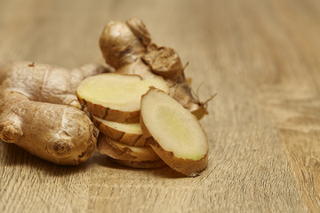 Ginger root sliced on wooden table