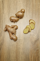 Ginger root sliced on wooden table