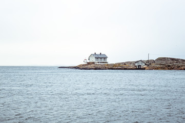 Tiny blue lighthouse on swedish coastline - 209509902