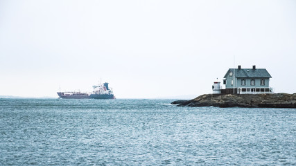 Tiny blue lighthouse on swedish coastline