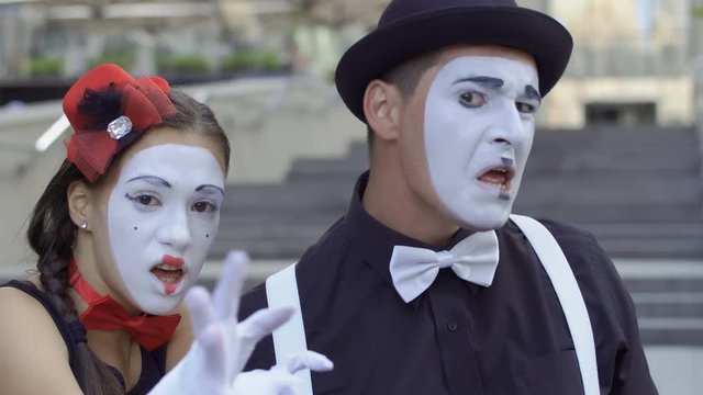 Girl and man mimes fooling around on camera