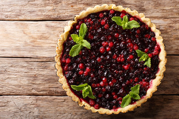 Homemade pie with summer berries and mint closeup in a baking dish. Horizontal top view from above