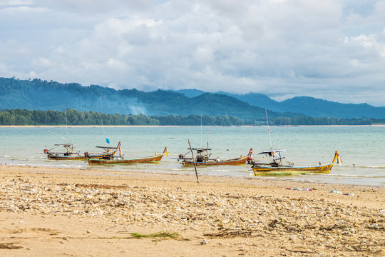 Four traditional Thai fishing boats anchored on Than Tawan beach in Thailand. They are motorboat and made of wood.