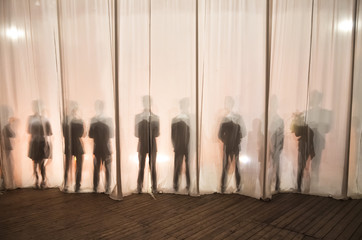 the silhouette of the men behind the curtain in the theater on stage, the shadow behind the scenes is similar to the white and black piano keys.