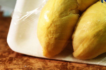 Durian fruit in foam containing tray.
