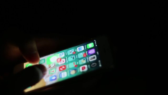 time lapse,Close up of man hands typing scrolling pictures phone at night.