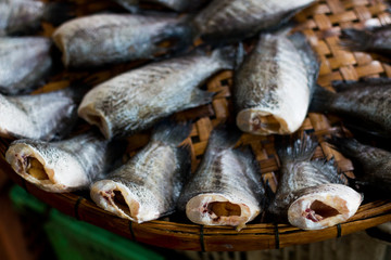 gourami dry fish for cooking . little animals dried with sun light . heap of cut meat prepared . cuisine background using .