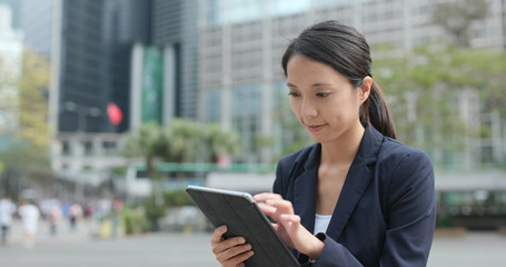 Businesswoman use of tablet computer at outdoor