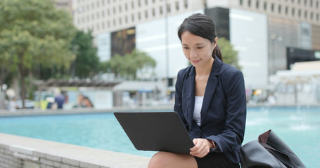 Fototapeta premium Businesswoman use of laptop computer at outdoor