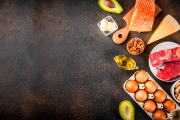 Ketogenic low carbs diet concept. Healthy balanced food with high content of healthy fats. Diet for the heart and blood vessels. Organic ingredients, dark rusty background, copy space top view