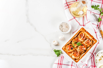 Homemade healthy diet dinner, prepared chicken turkey meatballs with sauce, cheese, greens. On a white marble table, with spices.  copy space top view