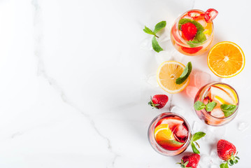 Cold white, pink and red sangria cocktails with fresh fruits, berries and mint.