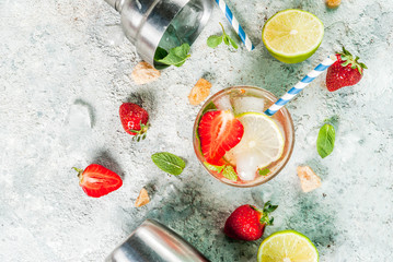 Summer refreshment drink, strawberry mojito cocktail on light concrete background, copy space