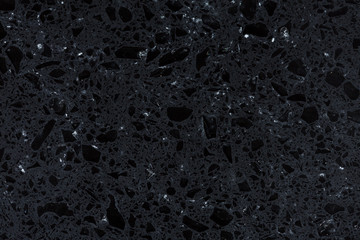 Fototapeta na wymiar Shiny exquisite background of black synthetic rock.