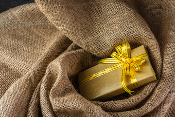 Gift box on sackcloth background