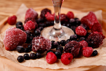 Refreshing cocktail with raspberries and alcohol, red. Decorated with fresh forest berries.