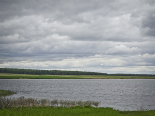 Summer landscape: a lake in cloudy weather
