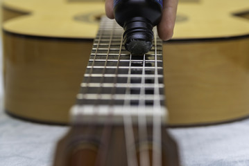 Care and maintenance of the strings of a guitar.