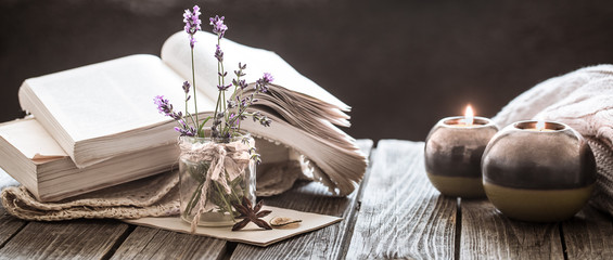 still life a book and a candle on a wooden table