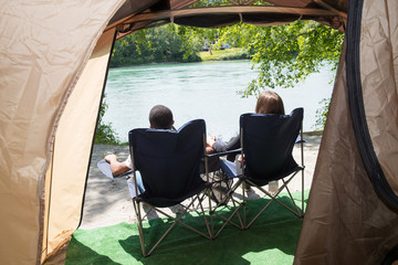 couple sitting together while camping